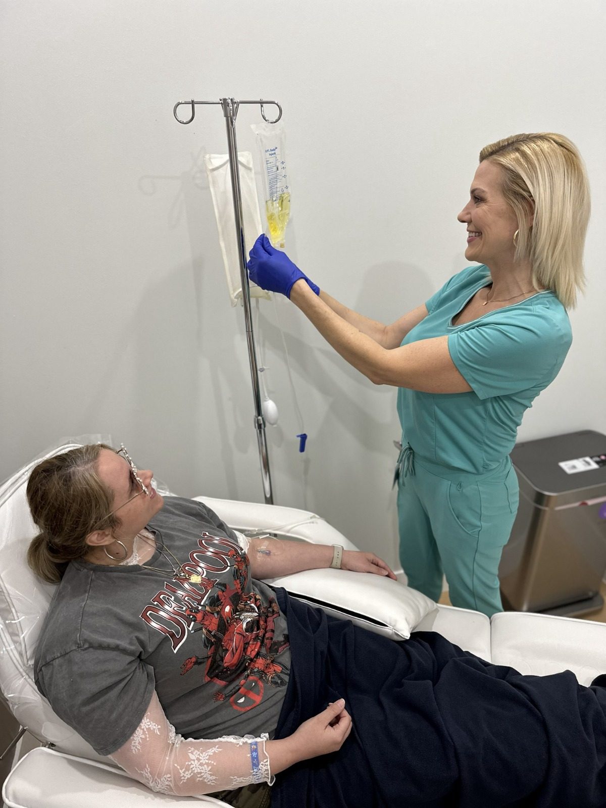 Clinical staff administering an IV drip